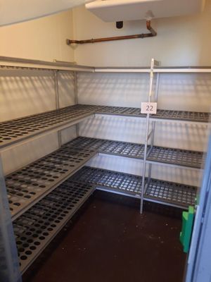 un réfrigérateur vide avec des étagères dans un coin de la pièce