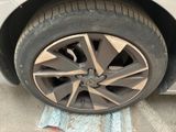 someone is changing the tire of a car on the street