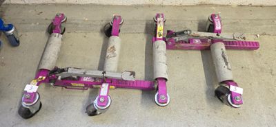 four pink scooters that are sitting on the ground