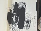 a black and white picture of a book with black ink on it