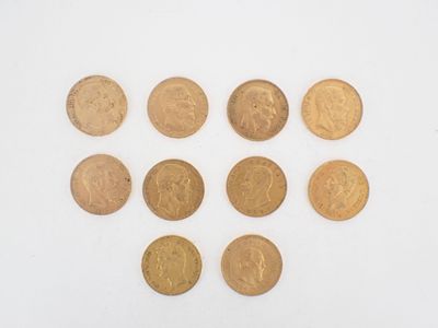 a close up of a group of gold coins on a white surface