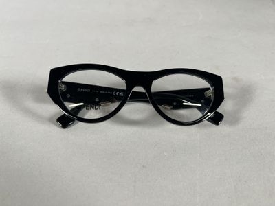 black glasses on a white surface with a white background