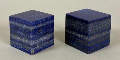 pair of blue marble salt and pepper shakers on a white surface