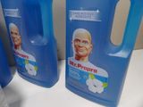 three gallon jugs of liquid sitting on top of a counter