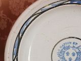 a blue and white plate with a flower design on it