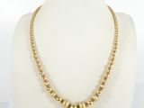 a gold beaded necklace on a mannequin mannequin mannequin mannequin mannequin mannequin mannequin mannequin mann