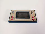 an old game console sitting on top of a white table