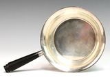 a silver plate with a black handle and a black handle