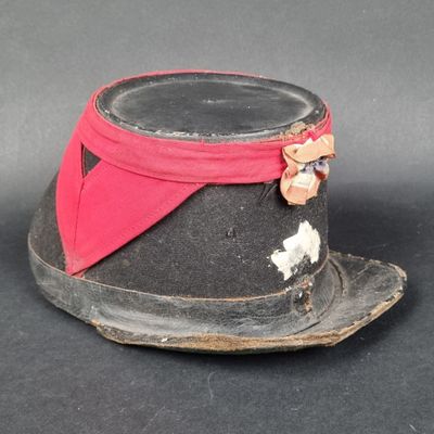 un chapeau noir orné d'un ruban rouge
