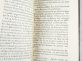 an open book on a table with a pen in it