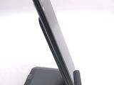 a cell phone that is on a stand on a table