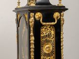 a black and gold clock sitting on a wooden table