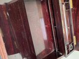 a wooden cabinet with a mirror on the wall