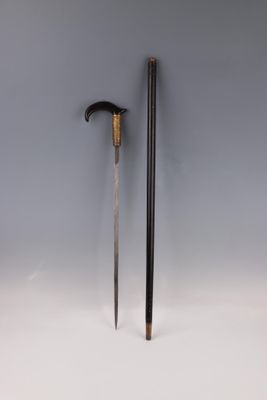 a pair of swords with a wooden handle on a white surface