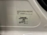a close up of a label on the side of a white car