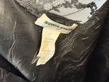 a close up of a black jacket with a label on it