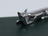 a silver fox broocht on a green cloth