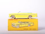 yellow toy car sitting on top of a yellow box on a white surface