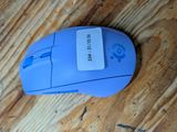 a blue mouse that is sitting on a wooden table