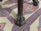 a close up of the legs of a table on a rug