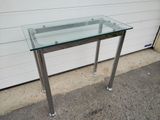 a glass table with a metal frame on it