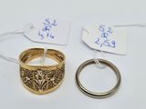 two gold rings and a ring with a price tag on it