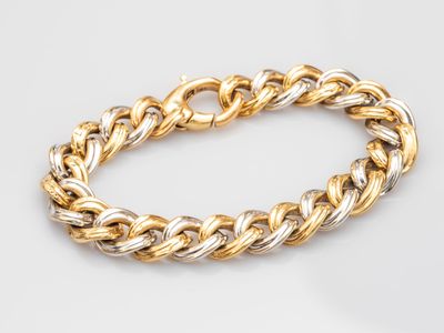 a gold and silver bracelet on a white background