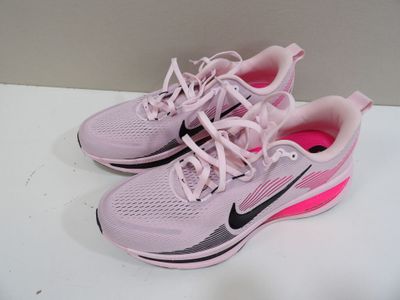 pink nike running shoes with pink laces are on a white surface