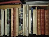 many books that are on a shelf in a book case