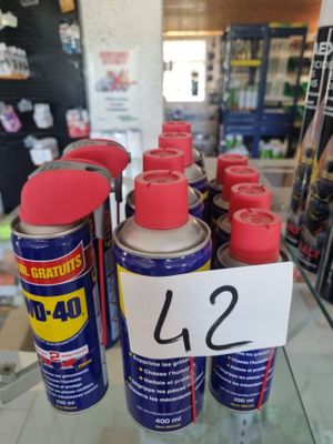 many cans of paint on a glass shelf in a store
