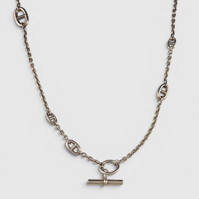 a close up of a chain with a cross on it