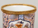 a close up of a vase with a gold rim