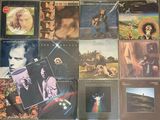 the album covers of various albums are displayed on a table
