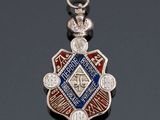 a close up of a silver and blue medal on a black surface
