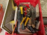 a red box filled with assorted tools on a table