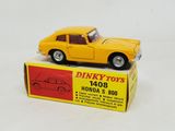 yellow toy car sitting on top of a box on a white surface