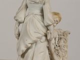 a figurine of a woman and a child on a table