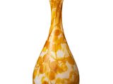 a yellow vase that is sitting on a white surface