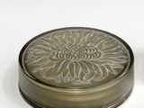 two small tins that are sitting next to each other