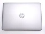 a laptop computer sitting on top of a white table