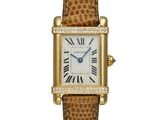 a lady ' s cartier tank watch with diamonds and leather strap