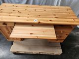 a wooden desk with a drawer on top of it