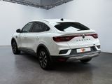 the rear end of a white suv parked in a garage