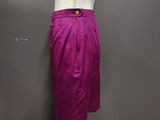 a white mannequine with a purple skirt on a wooden floor