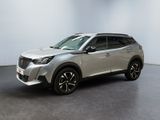 a silver suv parked in a large room with a black floor