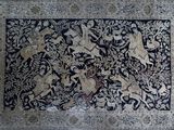 an antique persian rug with a black and white design on it