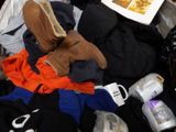 a pile of clothes and other items on the floor