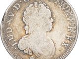 gros plan d'une pièce de monnaie sur laquelle figure une tête de femme