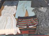 a pile of clothes that is sitting on a table