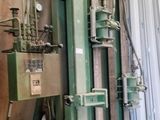 a machine that is sitting next to a pile of sheets of paper